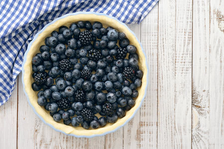 Tasty homemade pie with blueberries and blackberries on wooden table. Top view.の写真素材