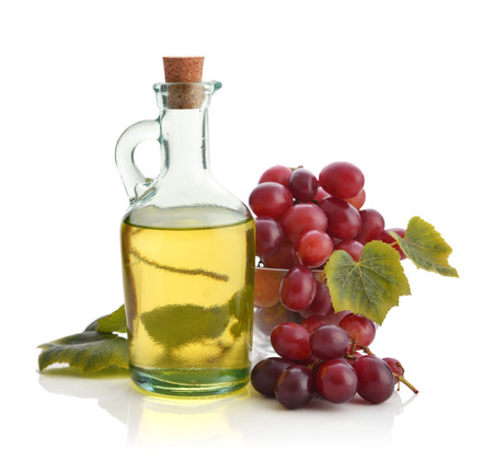 Grape seed oil in a glass jar isolated on white backgroundの写真素材