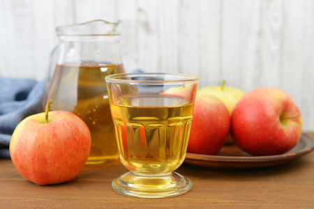 Apple juice with fresh apples on wooden  backgroundの写真素材