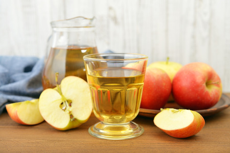 Apple juice with fresh apples on wooden  backgroundの写真素材