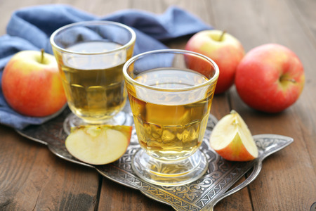 Apple juice with fresh apples on wooden  backgroundの写真素材