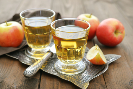 Apple juice with fresh apples on wooden  backgroundの写真素材