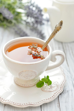 Lavender tea in cup closeup on wooden backgroundの写真素材