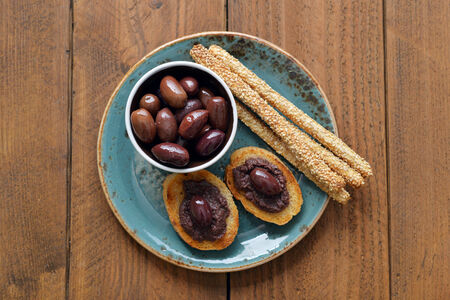 Bread with olive pate on plate closeup. Greek cuisineの写真素材
