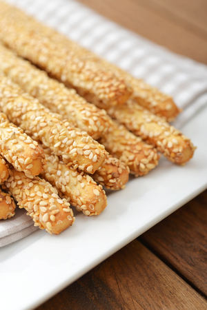 Bread sticks with sesame seeds on plate closeupの写真素材