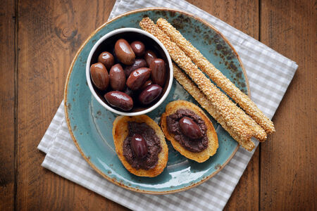 Bread with olive pate on plate closeup. Greek cuisineの写真素材