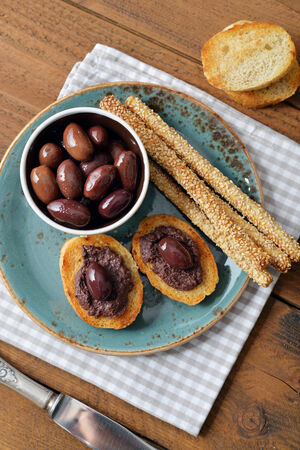Bread with olive pate on plate closeup. Greek cuisineの写真素材