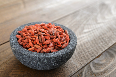 Bowl with goji berries on the table closeupの写真素材