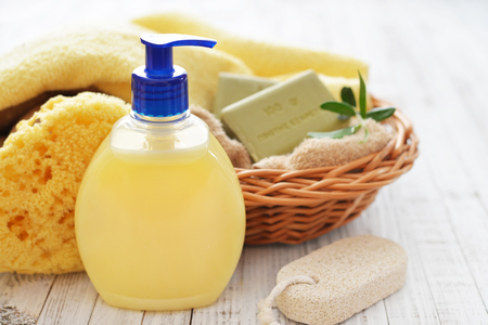 Shower gel with  olive soap and bath towels on wooden backgroundの写真素材