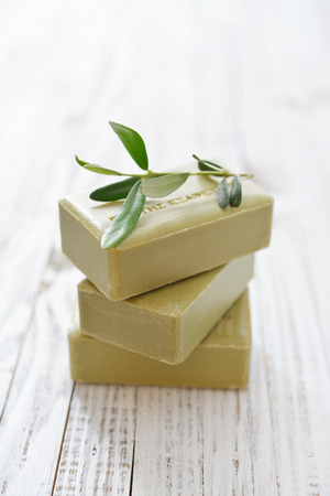 Greek olive soap with olive twig  on wooden backgroundの写真素材