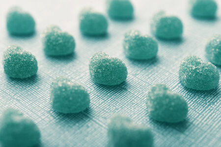 Candy in shape of hearts on blue backgroundの写真素材