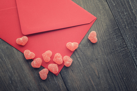 Red envelope with jelly candy in shape of hearts closeupの写真素材