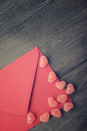 Red envelope with jelly candy in shape of hearts closeupの写真素材