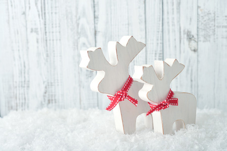 Christmas decoration in form of elks on light wooden backgroundの写真素材