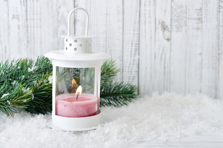 Christmas decorations with candle in lantern and fir tree on wooden backgroundの写真素材