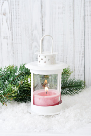 Christmas decorations with candle in lantern and fir tree on wooden backgroundの写真素材