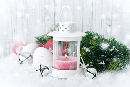 Christmas decorations with candle in lantern and fir tree on wooden backgroundの写真素材