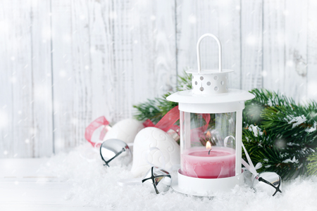 Christmas decorations with candle in lantern and fir tree on wooden backgroundの写真素材