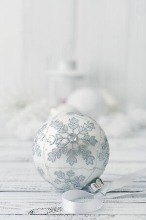 White christmas ball with decorations on light backgroundの写真素材