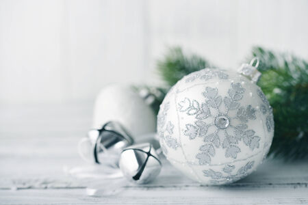 White christmas balls and fir branches with decorations on light backgroundの写真素材