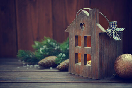 Christmas lantern in shape of small wooden house with candle insideの写真素材