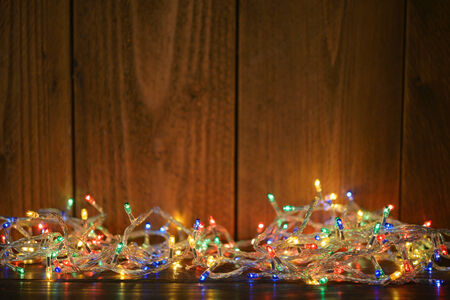 Christmas lights on wooden background. Selective focusの写真素材