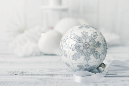 White christmas ball with decorations on light backgroundの写真素材