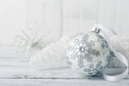 White christmas ball with decorations on light backgroundの写真素材