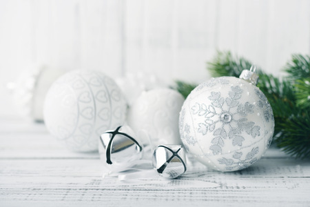 White christmas balls and fir branches with decorations on light backgroundの写真素材