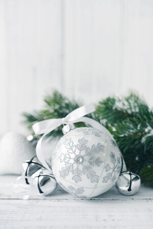 White christmas balls and fir branches with decorations on light backgroundの写真素材