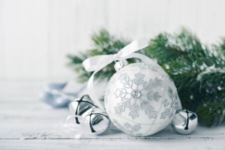 White christmas balls and fir branches with decorations on light backgroundの写真素材