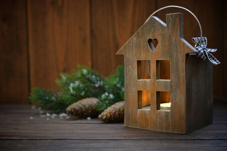 Christmas lantern in shape of small wooden house with candle insideの写真素材