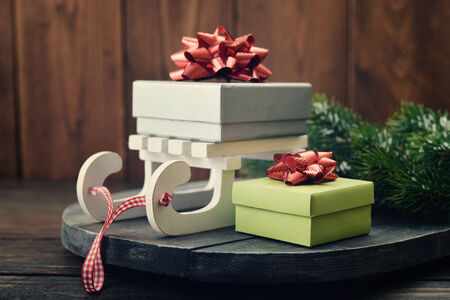 Gift boxes on decorative sled on wooden backgroundの写真素材