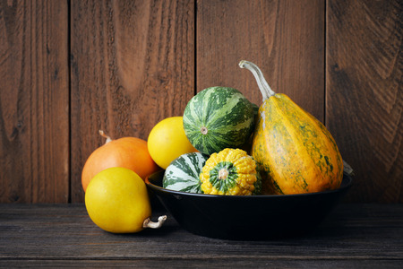 Small decorative pumpkins over wooden backgroundの写真素材