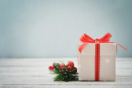 Gift box with ribbons and christmas decor on wooden backgroundの写真素材