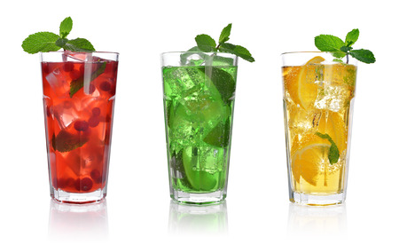Red berry cocktail drink with cranberry and ice isolated on whiteの写真素材