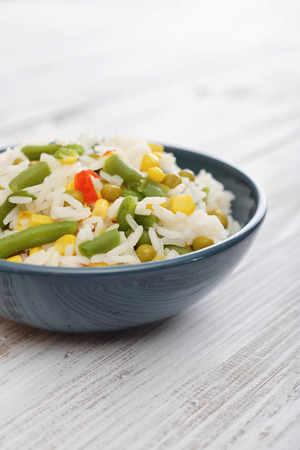 Vegetable risotto on plate on wooden backgroundの写真素材