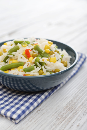 Vegetable risotto on plate with fork on wooden backgroundの写真素材