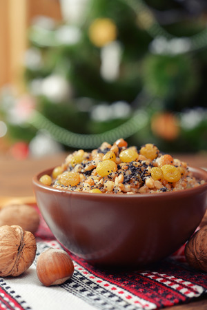 Traditional Christmas slavic dish kutia in ceramic bowl with fir treeの写真素材