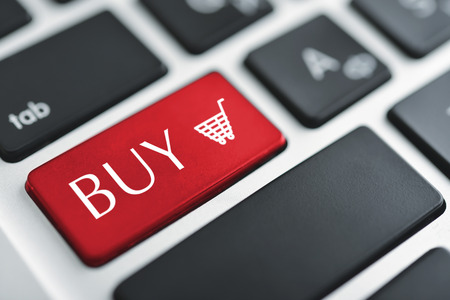 Shopping cart icon button on the key of a computer keyboardの写真素材