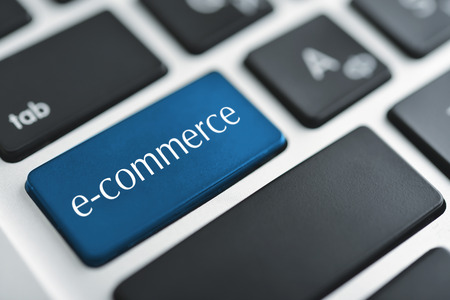 e-business key on a white keyboard closeup. E-commerce concept imageの写真素材