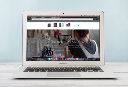 KIEV, UKRAINE - JANUARY 29, 2015: Brand new Apple MacBook Air Early 2014 with home page of Apple Inc. site presenting new iPad Air 2 on screen, designed and developed by Apple Inc., it was released on April 29, 2014のeditorial素材