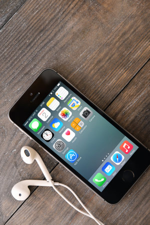 KIEV, UKRAINE - JANUARY 29, 2015: Brand new black Apple iPhone 5s, designed and developed by Apple Inc., it was released on September 20, 2013のeditorial素材