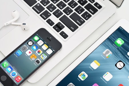 KIEV, UKRAINE - JANUARY 29, 2015: Apple iPhone 5s, iPad Air 2 and MacBook Air. Apple Inc. is an American multinational corporation that designs, develops, and sells consumer electronics.のeditorial素材