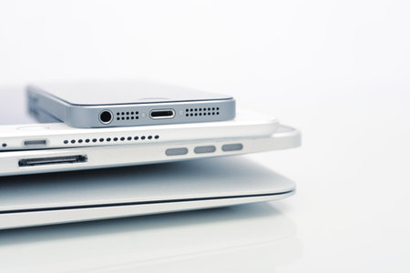KIEV, UKRAINE - JANUARY 29, 2015: Pile of Apple iPhone 5s, iPad Air 2 and MacBook Air . Apple Inc. is an American multinational corporation that designs, develops, and sells consumer electronics.のeditorial素材