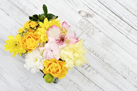 Beautiful bouquet of bright flowers on wooden background. Top viewの写真素材