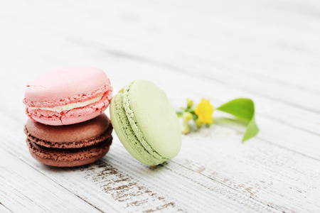 Colorful macaroons over white wooden backgroundの写真素材