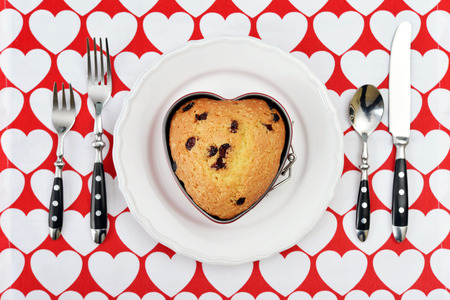 Freshly baked cranberry muffin in shape of heart. Top view.の写真素材