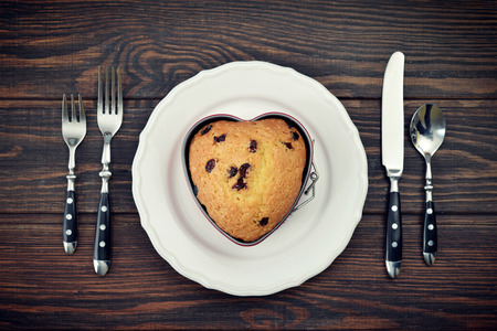 Freshly baked cranberry muffin in shape of heart. Top view.の写真素材