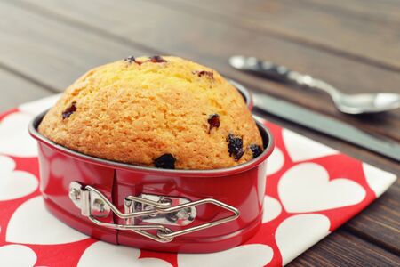 Freshly baked cranberry muffin in shape of heart.の写真素材
